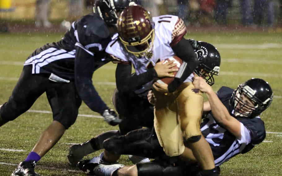 Matthew C. Perry ballcarrier Elijah Lebron tries to burrow his way through a gaggle of Zama defenders.