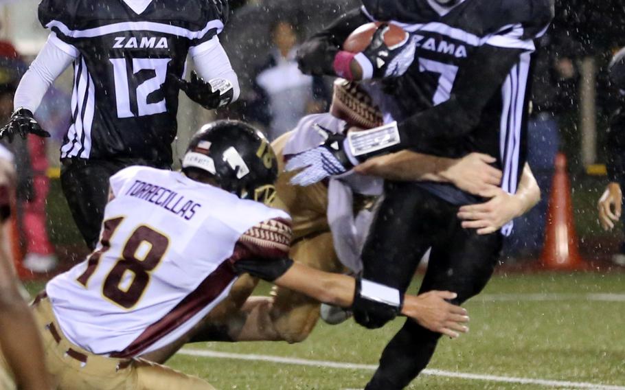 Zama ballcarrier Devonte Gabriel tries to weave his way between Matthew C. Perry defenders.