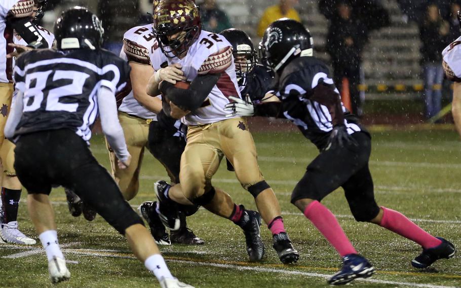 Matthew C. Perry ballcarrier Andrew Borrero makes his way between Zama defenders.