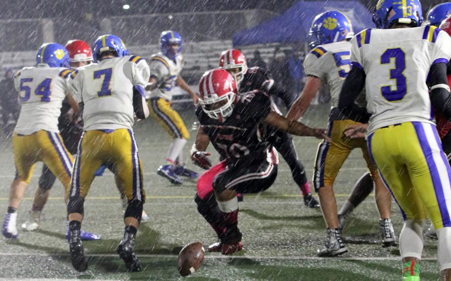 Nile C. Kinnick's Alvin Catabayan chases down a fumble between Yokota opponents.