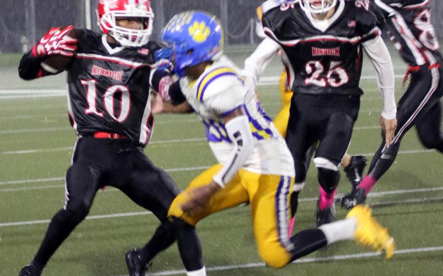 Nile C. Kinnick ball carrier Devoney Stanley avoids the tackle of Yoiota's Jimmy Dewberry.