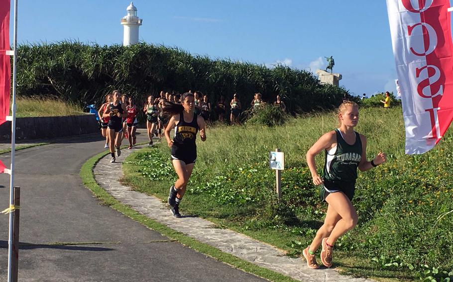 Kubasaki sophomore Elizabeth Joy leads the pack in the first lap around the 3.12-mile course at Cape Zampa, or Bolo Point. Joy won the Okinawa district girls race in a personal-best 20 minutes, 16 seconds.