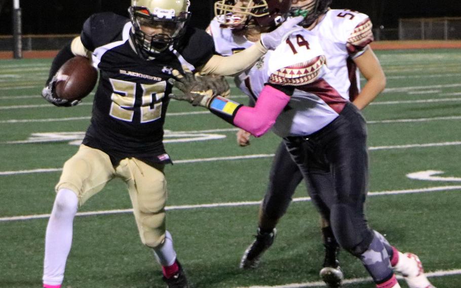 Humphreys running back Josh Weaver tries to elude Matthew C. Perry's Garrett Macias and Mason Graydon during Friday's football game, won by the Samurai 20-10.