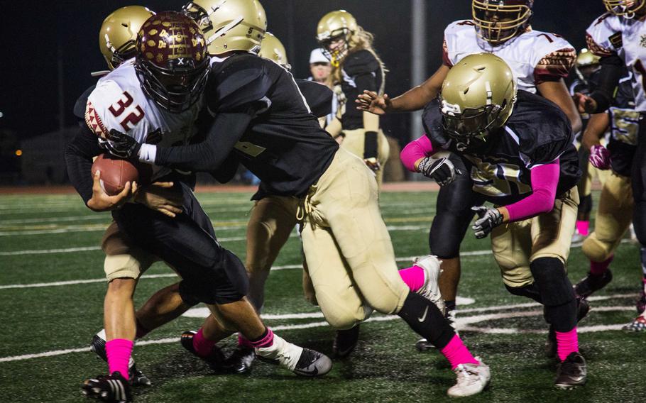 Matthew C. Perry senior Andrew Borrero gets gang tackled by Humphreys at Camp Humphreys, South Korea, Friday, Oct. 3, 2017.  Perry won 20-10. 