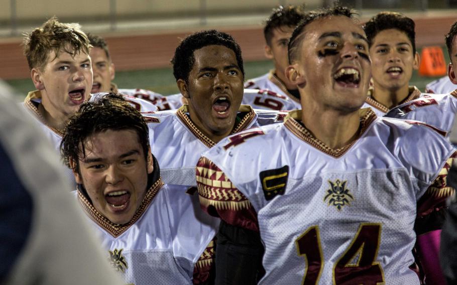 Mathew C. Perry football players celebrate their 20-10 victory over Humphreys at Camp Humphreys, South Korea, Friday, Oct. 13, 2017. 