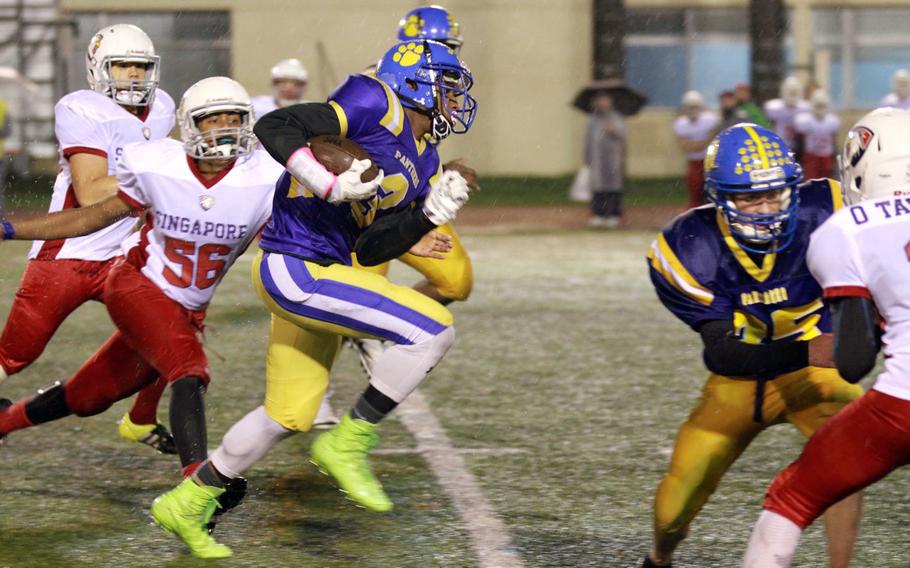 Yokota's Kishaun Kimble-Brooks takes off on a long run against Singapore during Monday's football game, won by the Panthers 25-6.