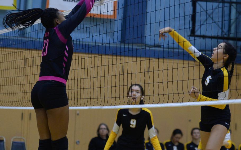 American School In Japan's Ariel Fuchs has a shot blocked by Yokota's Britney Bailey during Wednesday's volleyball match, won by the Mustangs 25-15, 25-19, 28-26.