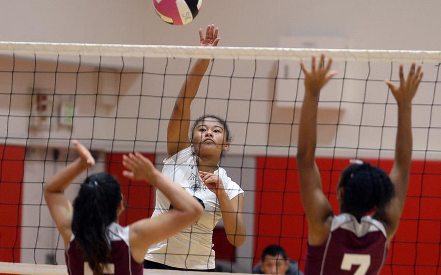 Zama's Grace Bryant smacks a spike over Matthew C. Perry's Anna Garcia and Brie Barrett during Friday's DODEA-Japan/Pac-East girls volleyball tournament knockout bracket match. The Trojans won 25-18, 25-23, 25-19 to advance to Saturday's elimination match with E.J. King. 