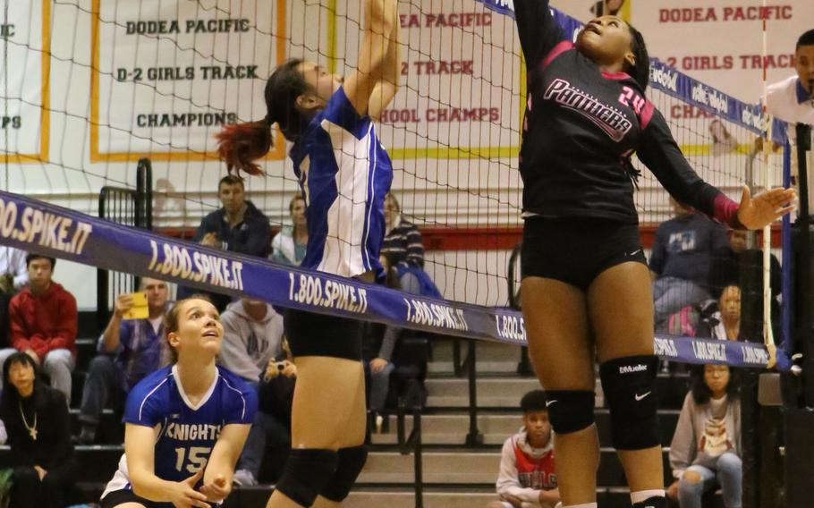 Yokota's Kyra Anderson goes up to swat the ball back over the net against Christian Academy Japan.