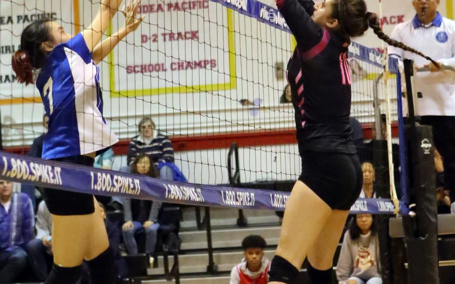Christian Academy Japan's Keziah Sou and Yokota's Adrianna Diaz battle at the net.