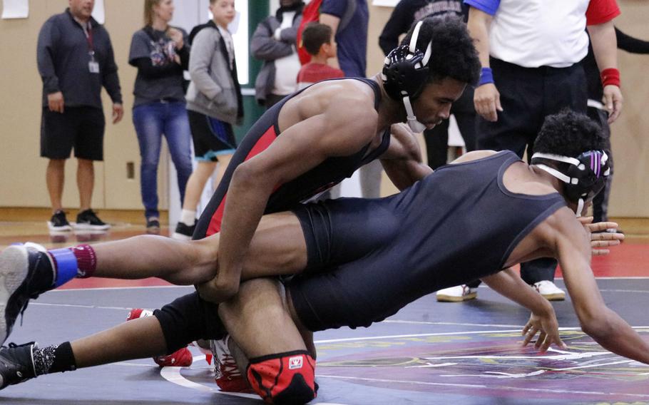Nile C. Kinnick's Devoney Stanley takes control of Matthew C. Perry's Bryan Williams in the 135-pound final bout.