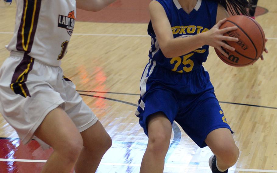 Yokota's Emily Taynton is guarded by Matthew C. Perry's Madison Swieczkowski during Friday's Japan girls basketball game, won by the Panthers 44-8.