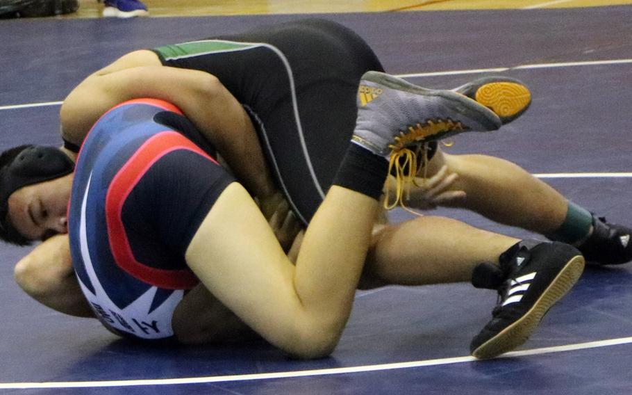 Humphreys' Devin Rix gets the upper hand on Seoul American's Franklin Matthews during Saturday's three-way dual-meet wrestling event at Seoul American. Rix won the 158-pound bout by technical fall.