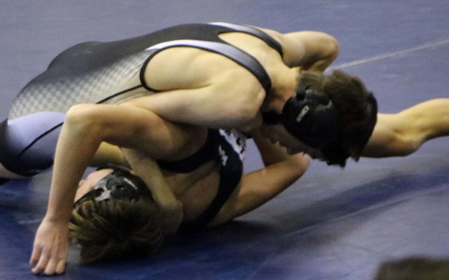Humphreys' Sam Lister gains the advantage on Seoul American's Logan Prather during Saturday's three-way dual-meet wrestling event at Seoul American. Lister won the 115-pound bout by technical fall.