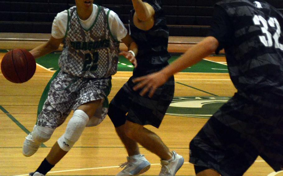 Kubasaki's Elonzo Higginson III dribble drives against Zion Christian during Saturday's Okinawa boys basketball game, won by the Dragons 76-48.