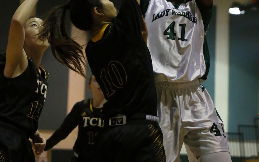 Daegu's DaiJa Turner shoots over two Taejon Christian International defenders during Wednesday's Korea Blue girls basketball game, won by the Warriors 32-29.
