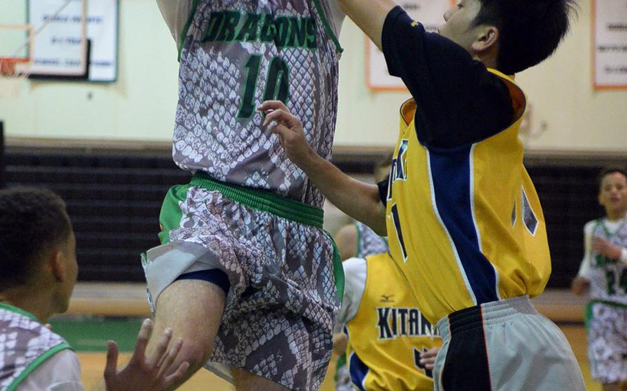 Kubasaki's Jonathan Hoppe drives toward the basket against Kitanakagusuku during Friday's boys basketball game, won by the Dragons 81-59.