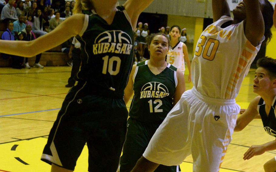 Kubasaki's Hailey Hansen and Kadena's Atiria Simms sky for a rebound during Friday's girls basketball game, won by the Panthers 52-15.