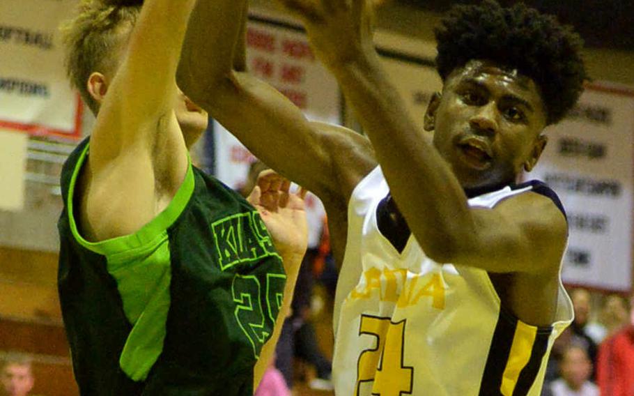 Kadena's Montez Young Jr. and Kubasaki's Jonathan Baker scrap for a rebound during Friday's boys basketball game, won by the Panthers 40-39.