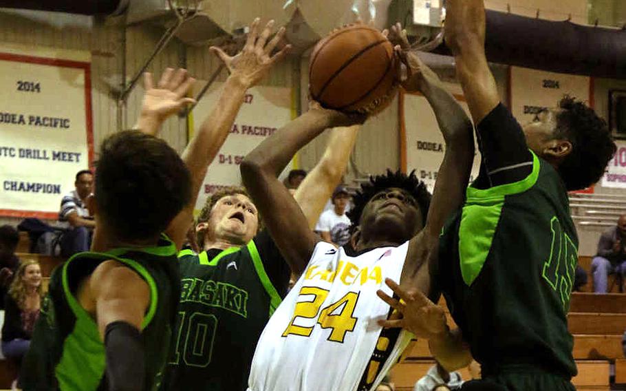 Kadena's Montez Young Jr. shoots between Kubasaki's Jhean Natividad, Jonathan Hoppe and Ilijah Washington during Friday's boys basketball game, won by the Panthers 40-39.