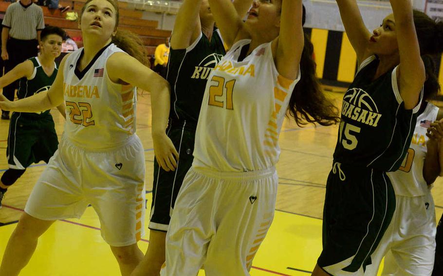 Kadena's Isabel Tayag puts up a shot between Kubasaki's Hailey Hansen and Brandi Smith during Friday's girls basketball game, won by the Panthers 52-15.