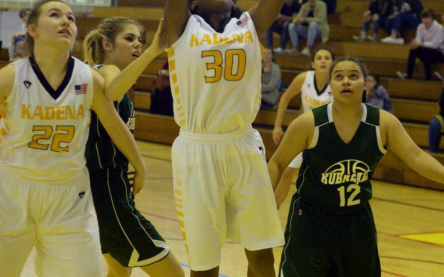 Kadena's Atiria Simms goes up for a shot against Kubasaki during Friday's girls basketball game, won by the Panthers 52-15.