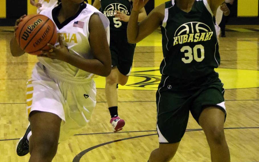 Kadena's Kaylee Lewis drives to the basket against Kubasaki's Nahla Wilson during Friday's girls basketball game, won by the Panthers 52-15.