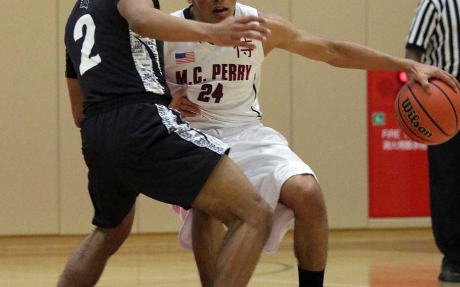 Matthew C. Perry's Jonathan Armijo dribbles against Zama's Jeremiah Stewart during Friday's Japan boys basketball game, won by the Trojans 56-37.