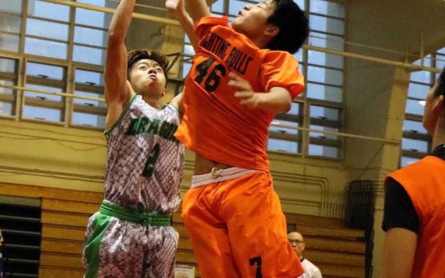 Kubasaki's Jhean Natividad shoots over a Maehara defender during Sunday's boys championship game in the 12th Okinawa-American Friendship Basketball Tournament. The Dragons downed the Fighting Bulls 68-54 for their fourth title in six finals appearances since the tournament's inception in 2007.
