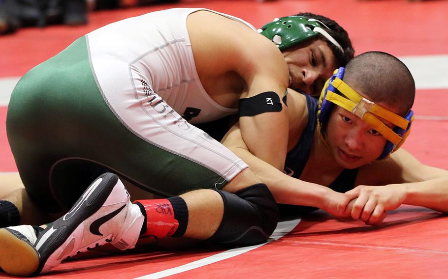 Kubasaki's Luis Veliz gains the upper hand on Masaya Ishizawa of Shonan Military Academy in the 115-pound final bout during Saturday's 25th Nile C. Kinnick Invitational "Beast of the Far East" Wrestling Tournament. Veliz won by technical fall 11-0 in 4 minutes, 4 seconds.