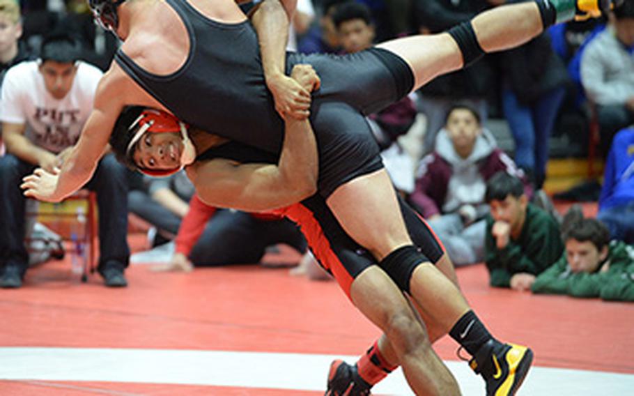 Nile C. Kinnick's Darius Swenson lifts and scores a two-point throw on Matthew C. Perry's Andrew Borrero in the 158-pound final during Saturday's 25th Nile C. Kinnick Invitational "Beast of the Far East" Wrestling Tournament. Swenson beat Borrero by decision 9-6.