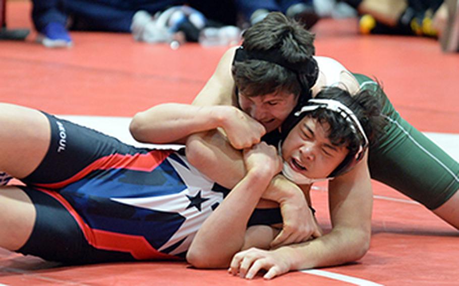 Kubasaki's Nick Burwell gets the edge on Seoul American's Brian Choe in the 180-pound final during Saturday's 25th Nile C. Kinnick Invitational "Beast of the Far East" Wrestling Tournament. Burwell won by technical fall 12-1 in 4 minutes, 24 seconds.