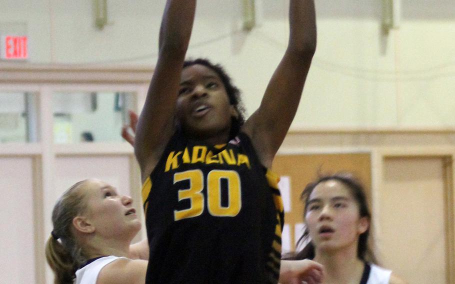 Kadena's Atiria Simms rebounds against Taipei American during Saturday's girls game in the 3rd Taipei American Basketball Exchange. The Panthers beat the Tigers 56-37.