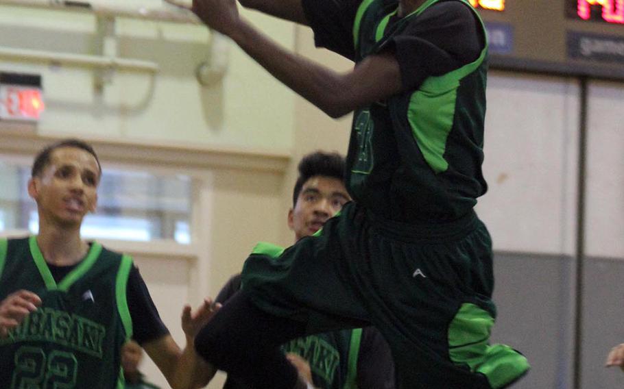 Kubasaki's Damien Dorval puts up a shot against Taipei American during Sunday's boys game in the 3rd Taipei American Basketball Exchange. The Dragons beat the Tigers 63-51.