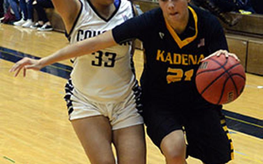 Kadena's Isabel Tayag drives against Academy of Our Lady of Guam's Rosita Duenas during Thursday's pool-play game in the 2nd American School In Japan Kanto Classic Basketball Tournament. The Cougars edged the Panthers 41-37.