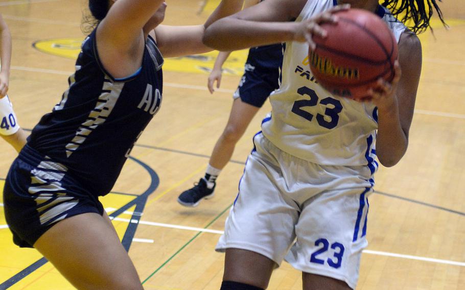 Yokota's Britney Bailey looks for room against Academy of Our Lady of Guam's Mika Dela Cruz during Friday's girls pool-play game in the 2nd American School In Japan Kanto Classic Basketball Tournament. The Panthers routed the Cougars 47-16.