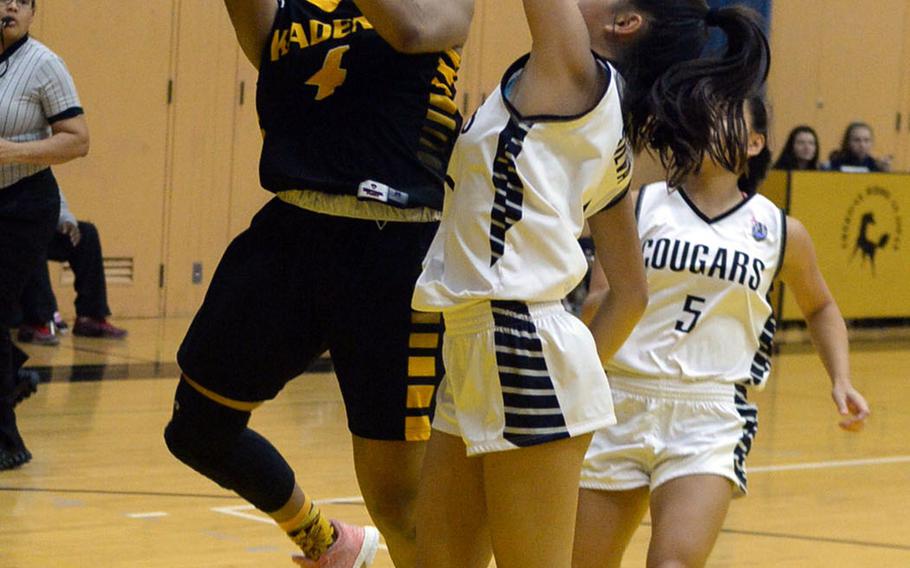 Kadena's Rhamsey Wyche, named the Player of the Tournament, puts up a layup past two Academy of Our Lady of Guam defenders during Saturday's girls final in the 2nd American School In Japan Kanto Classic. The Panthers downed the Cougars 45-35.