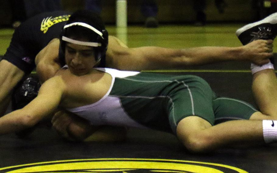 Kadena's Demetrio Delarosa gets the upper hand on Kubasaki's James Carpenter in the 129-pound bout during Thursday's Okinawa wrestling dual meet. Delarosa won by technical fall 14-4 in 4 minutes, 49 seconds, but the Dragons won the dual meet 52-12 and swept the regular-season series.
