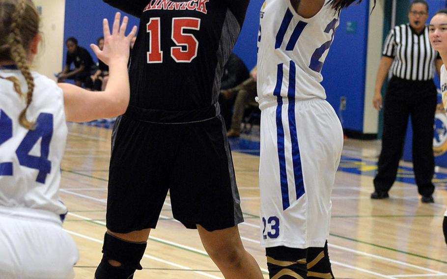 Nile C. Kinnick's Teddy Bates shoots against Yokota's Britney Bailey during Friday's Japan-Kanto Plain girls basketball game. The Panthers won on senior night 51-27 over the Red Devils.