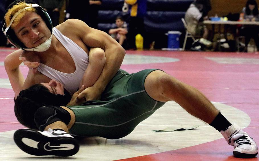 Kubasaki's Luis Veliz gets a head and arm hold on Humphreys' Sam Lister at 115 pounds during Thursday's semifinal bout in the 41st Far East Wrestling Tournament. Veliz pinned Lister in 26 seconds.