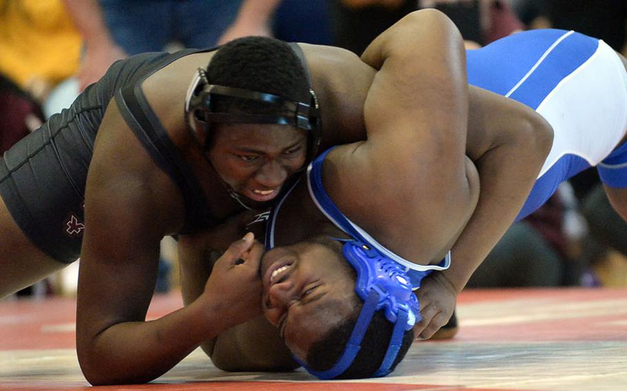 Matthew C. Perry's Marshall China wrenches Yokota's Jalen Harrison's shoulders to the mat in the heavyweight final during Friday's individual portion of the 41st Far East High School Wrestling Tournament. China pinned Harrison in 4 minutes, 4 seconds.