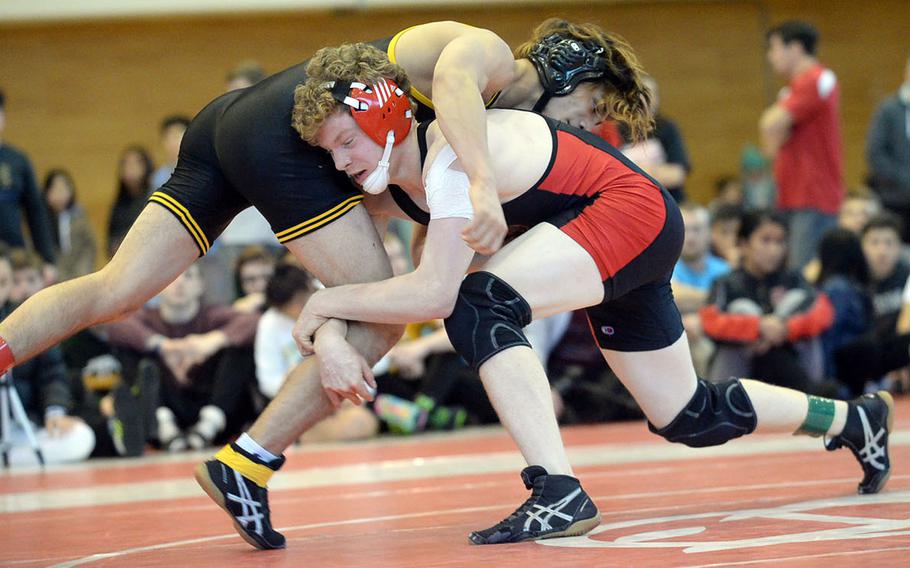 Nile C. Kinnick's Mason Smith gains a brief edge on American School In Japan's Rin Zoot in the 141-pound final during Friday's individual freestyle portion of the 41st Far East High School Wrestling Tournament. Smith edged Zoot in the closing seconds 14-13.