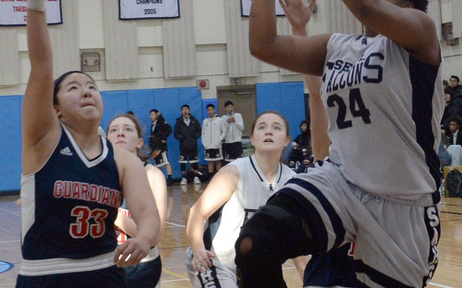 Seoul American guard Krista Bradley, the two-time tournament MVP, pulls up and shoots against Yongsan's Jasmine Chang during Friday's final in the Korea Blue Division girls basketball tournament. The Falcons routed the Guardians 46-25.