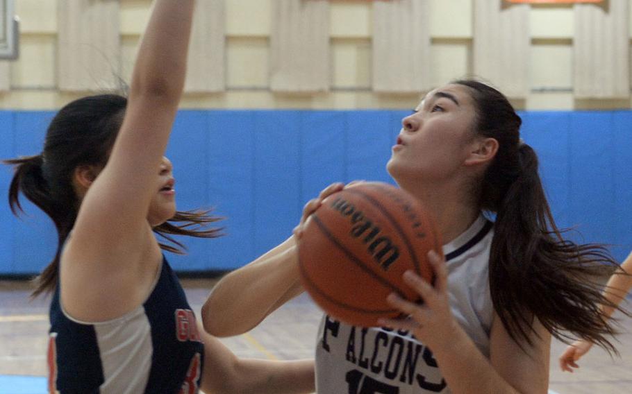 Seoul American forward Renee Thompson shoots against Yongsanl's Rachael Ko during Friday's final in the Korea Blue Division girls basketball tournament. The Falcons routed the Guardians 46-25.