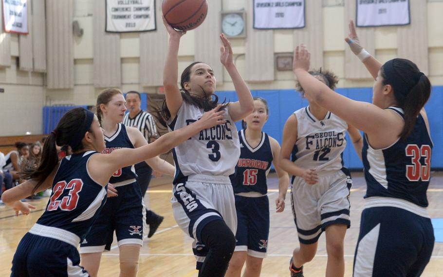 Seoul American guard Maria Bruch drives and shoots against the Yongsan's defense during Friday's final in the Korea Blue Division girls basketball tournament. The Falcons routed the Guardians 46-25.