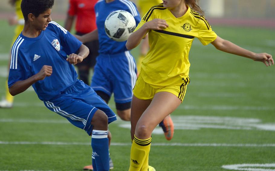 Kadena's Adrianna Gomez and Aidan Davis of Okinawa Diplomats FC's U-15 side battle for the ball during Friday's Okinawa soccer match. The Panthers prevailed 2-1.
