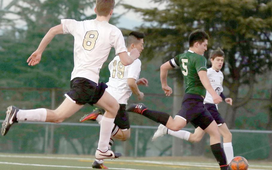 Daegu's Miciah Ruff heads downfield en route to the team's lone goal, with Humphreys' Teige Heckenlaible, Jason Holcomb and Sam Lister in his wake, during Friday's Korea boys soccer match. The Blackhawks won 4-1.