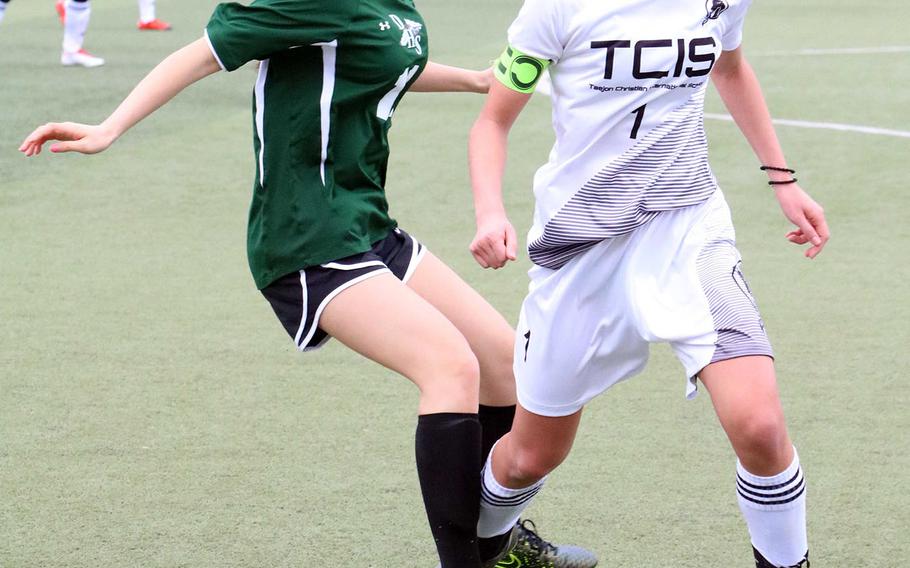 Daegu's Sunny Yang and Taejon Christian's Libby Chun circle back to the ball during Wednesday's Korea Blue girls soccer match, won by the Dragons 3-1.
