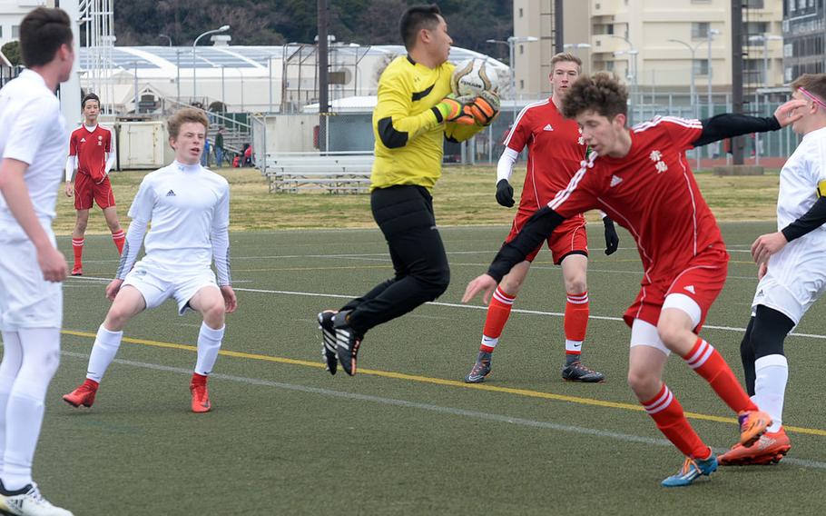 Robert D. Edgren keeper Cyril Yalung goes up to snag a corner kick against Nile C. Kinnick during Saturday's DODEA-Japan boys soccer match. The Red Devils blanked the Eagles 5-0.