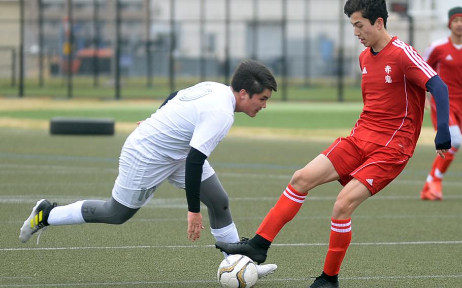 Nile C. Kinnick sophomore Kai Sullivan, controlling the ball against Robert D. Edgren's Ben Christenson, scored four goals Saturday, including three within a four-minute span, as the Red Devils blanked the Eagles 5-0.